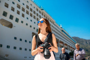 Woman tourist near the big cruise liner